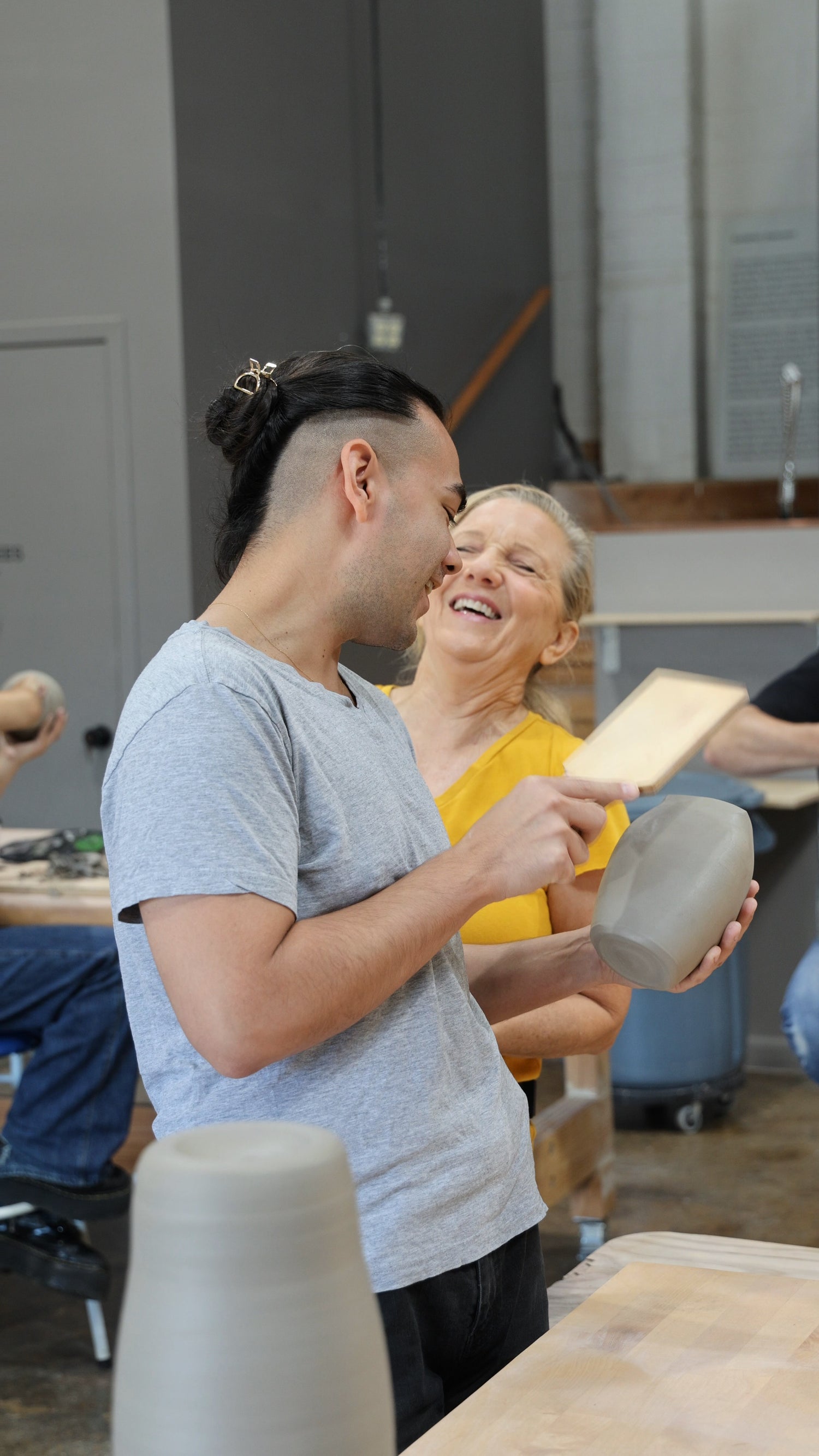 Students laughing while finishing their projects at Tao of Clay workshop.