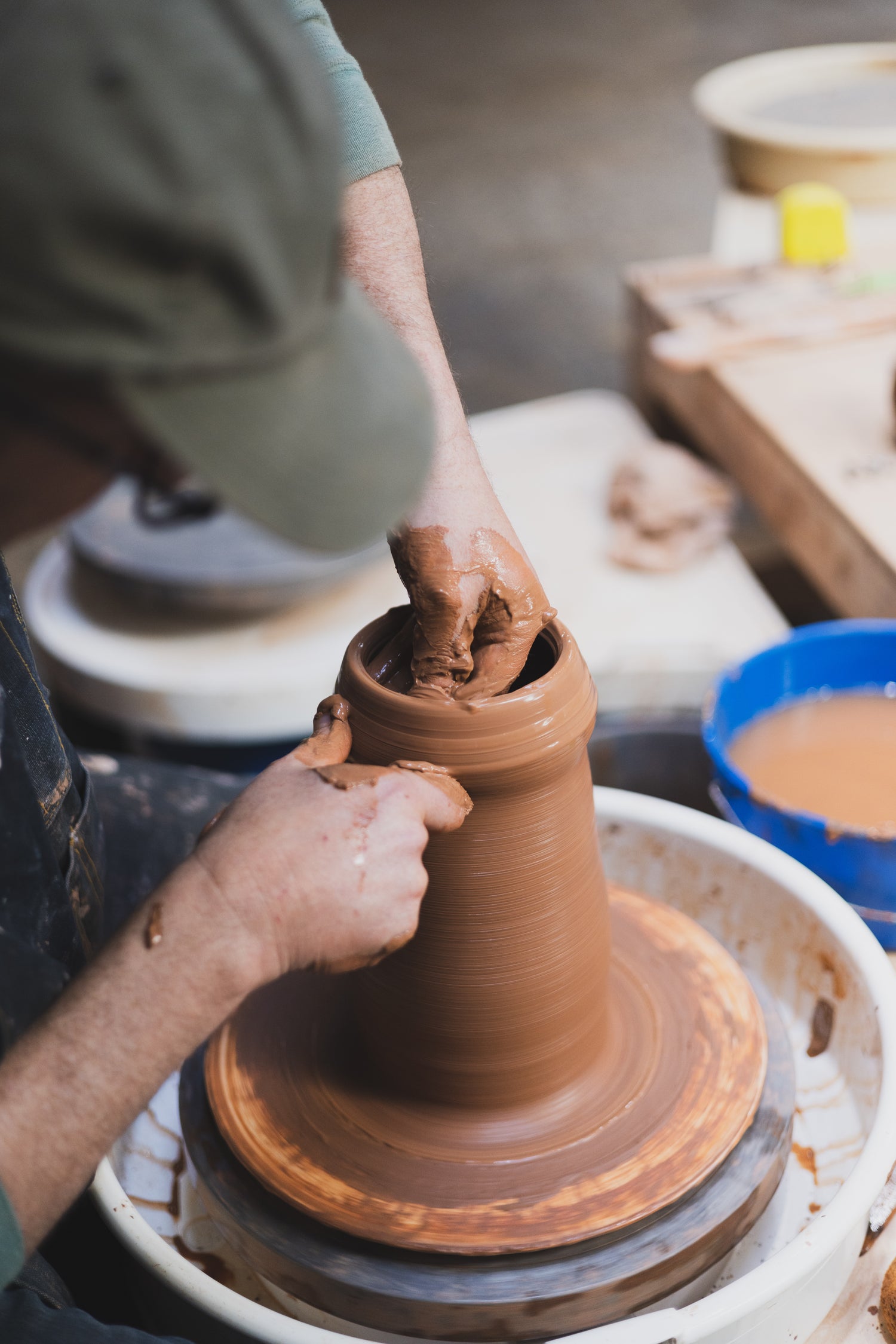 A man has his hand in pottery at Tao of Clay in Barrio Logan.