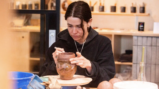 San Diego ceramic artist Bibi Belo carves designs into a small vase at Tao of Clay. 